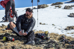 Team member Jeremy taking a minute to rub down his feet after a long day's work toward the top of St. Mary's Glacier. Photo Credit: Rob Jackson