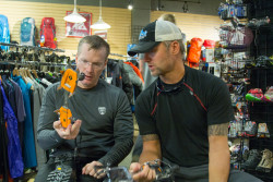 Team member Stuart works with expedition leader Jeff Evans to get his crampons fit at Bent Gate Mountaineering. Photo credit: Rob Jackson