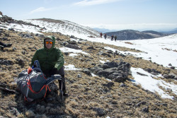 Team member Jeff takes a seat to wait for more of the team during the James Peak climb.