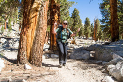 Stevi holds up piece signs as she rounds a corner during the hike